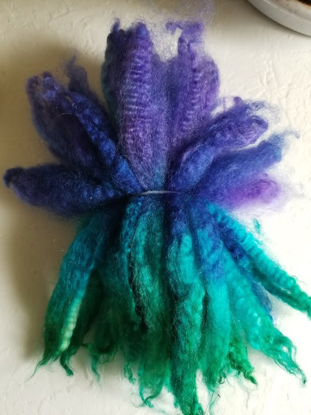 Aquatic dyed wool long locks in purple, green, and blue